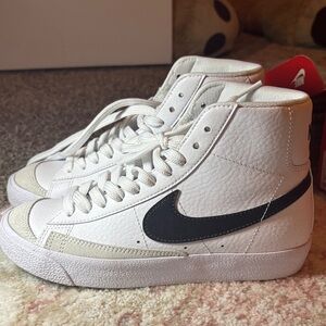 Nike White High-Top Sneakers with Black Swoosh